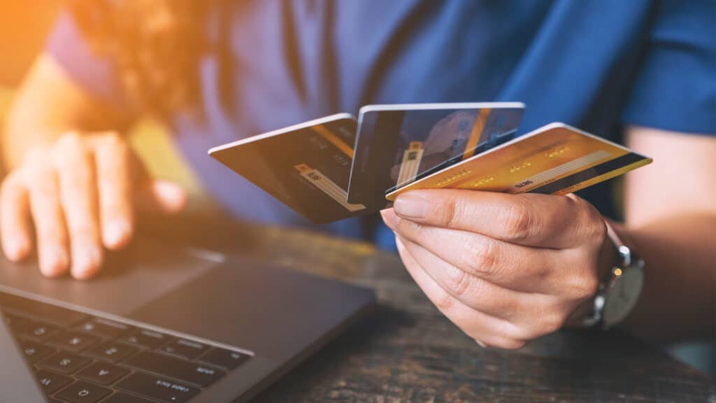 a person holding credit cards
