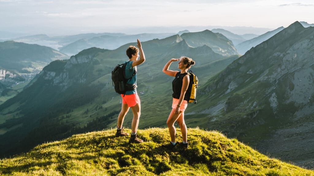 two people high five after hike