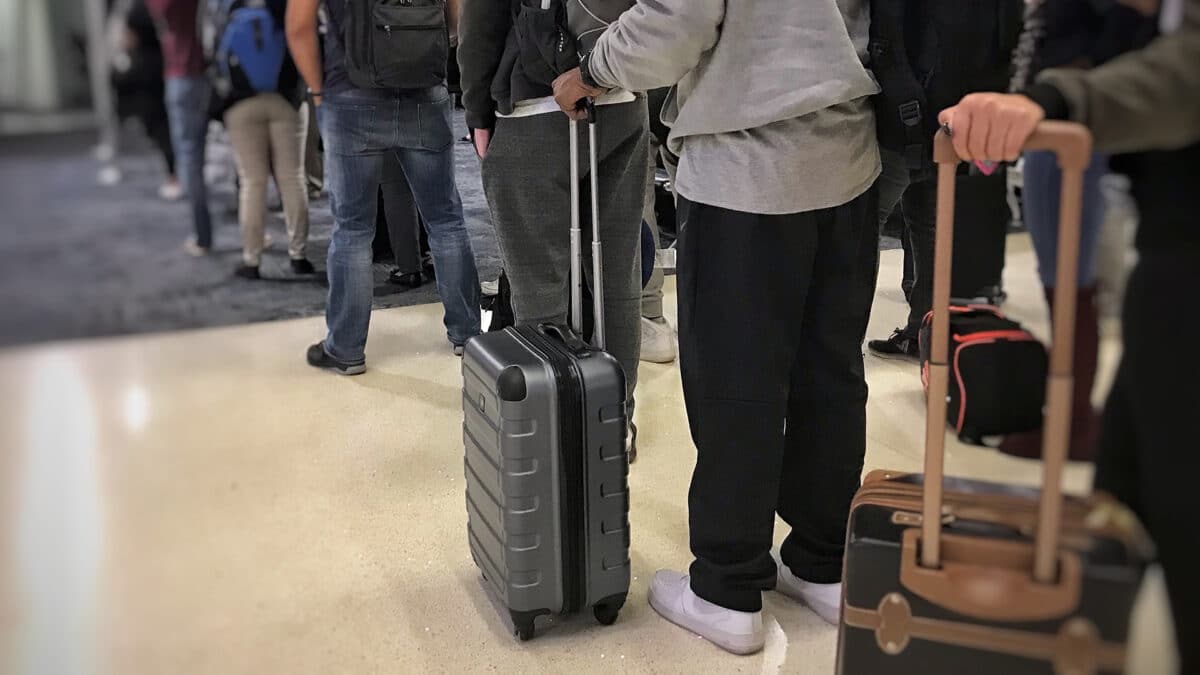 people wait in line at the airport