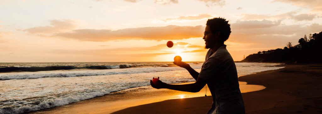 person juggling on beach