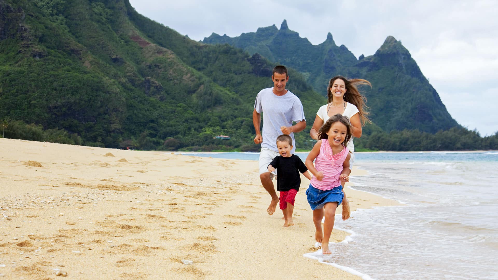 family running on the beach in Hawaii
