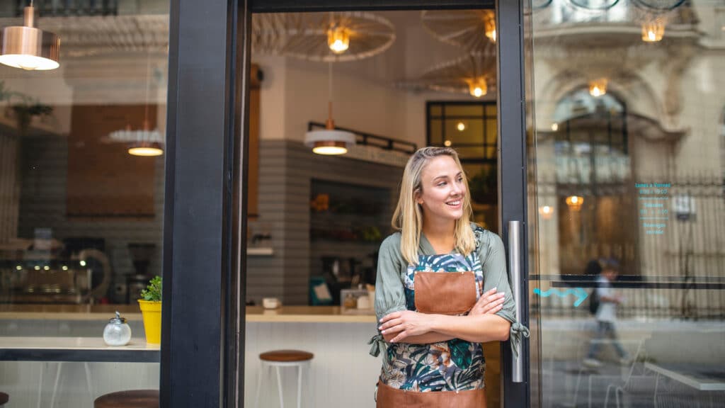 cafe owner standing outside cafe