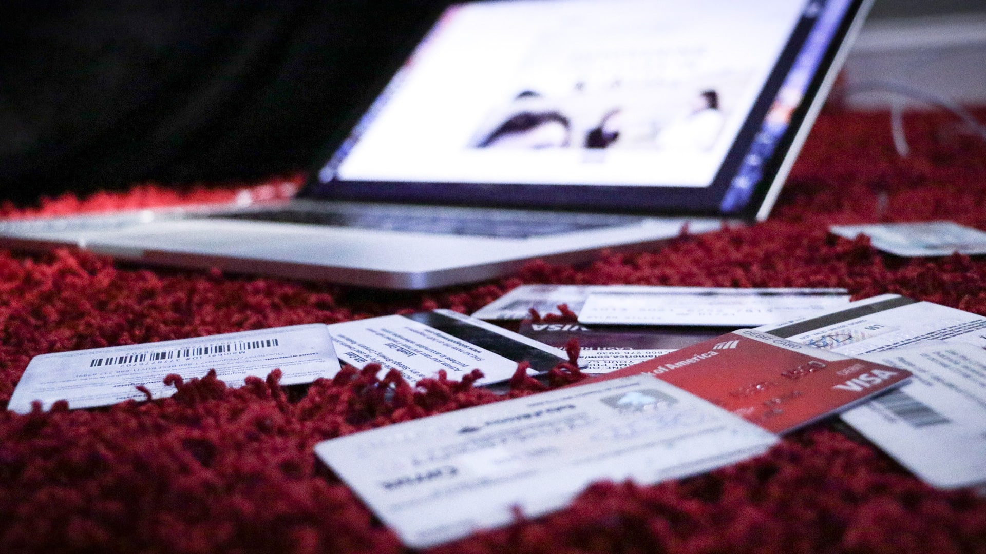 credit cards on the ground near a computer