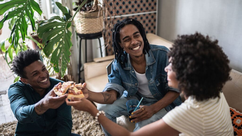 roommates eating pizza together