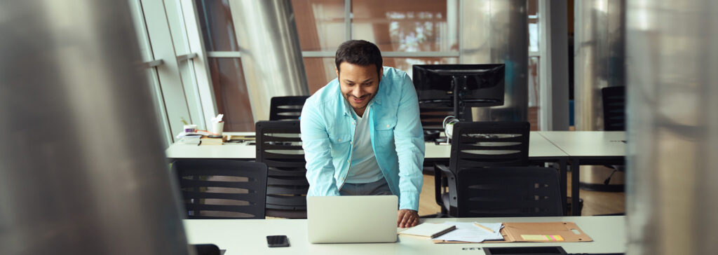 man in office looking at computer