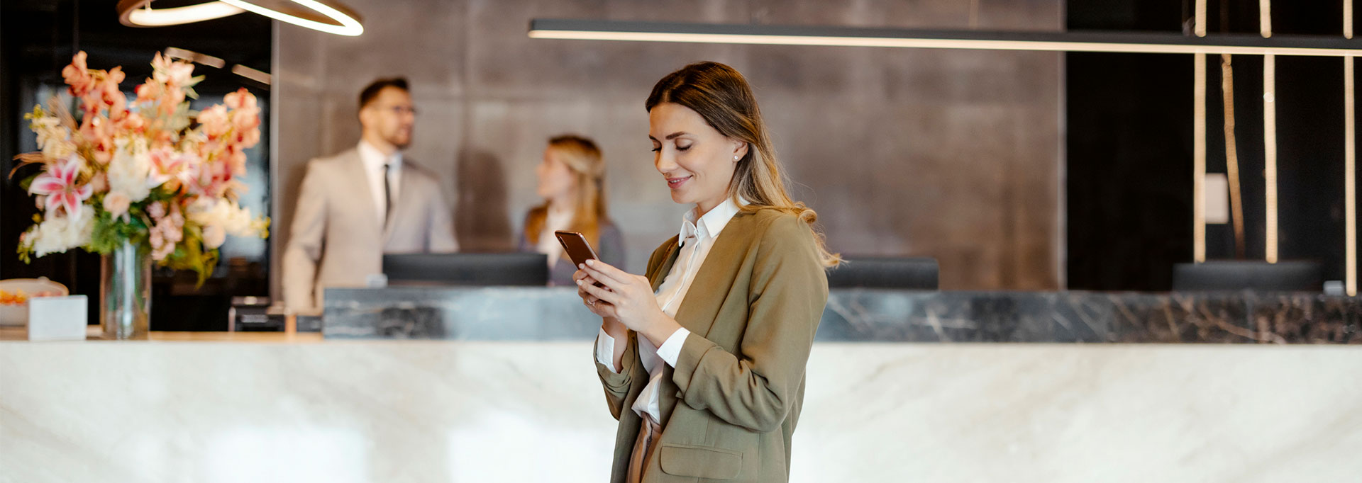 woman at hotel check in on mobile