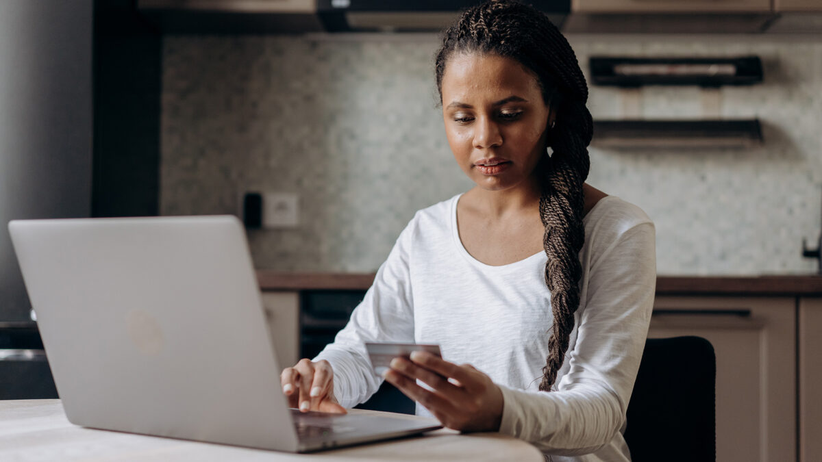 woman paying credit card on computer