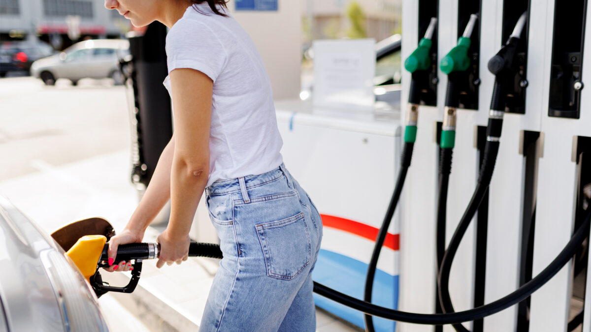 woman at gas station pumping gas